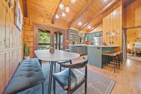 View of the open concept dining area with kitchen in the background.