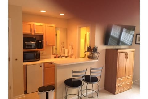 Kitchenette and dining bar. 50" TV