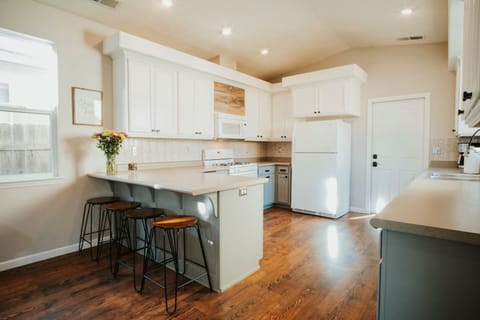 Enjoy morning coffee or late-night snacks at the kitchen island, perfect for casual conversations and connecting.