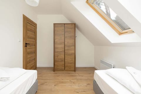 Upstairs bedroom with two single beds and closet.