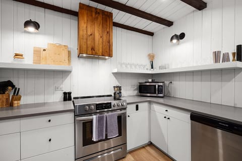 Every detail covered — full-size fridge, stove, microwave, blender, knife block, and all cookware included.