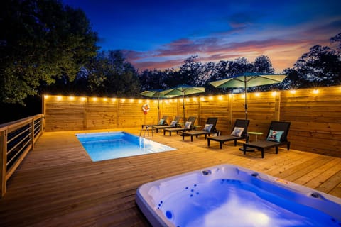 Nighttime glow-up: soak in the lit-up pool and hot tub under the Texas sky — unforgettable evenings await.