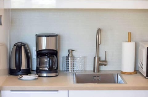 The kitchen counter is equipped with a coffee machine and an electric kettle for preparing your favourite drinks. 