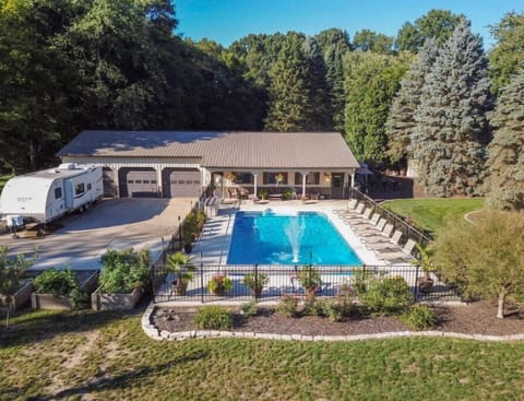 The Pool Barn Camper sits in the drive of our Pool Barn