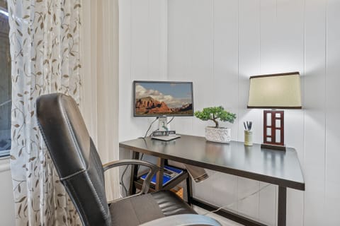 Work space with a monitor to catch up on important emails or take zoom calls.