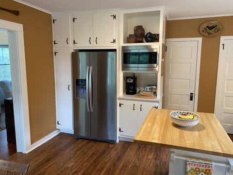Coffee, toaster + microwave nook of the kitchen, doorways to pantry +basement
