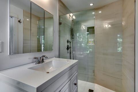L-shaped tranquil new bathroom w large vanity, walk in shower
