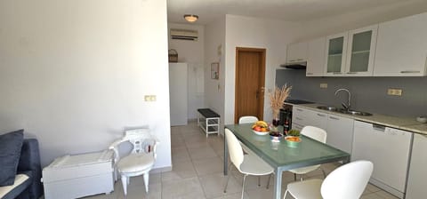 Apt Blue open plan kitchen with dining area