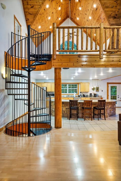 Spiral staircase leads to the loft bedroom, bathroom and down to game room