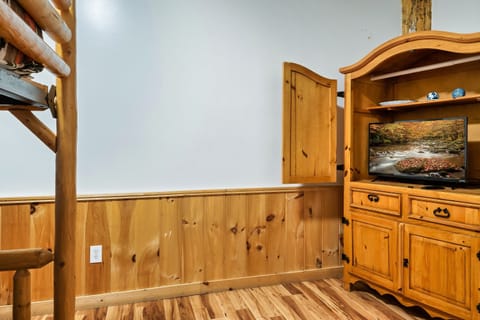 Second bedroom equipped with smart tv and dresser