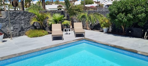 A heated pool, sun loungers