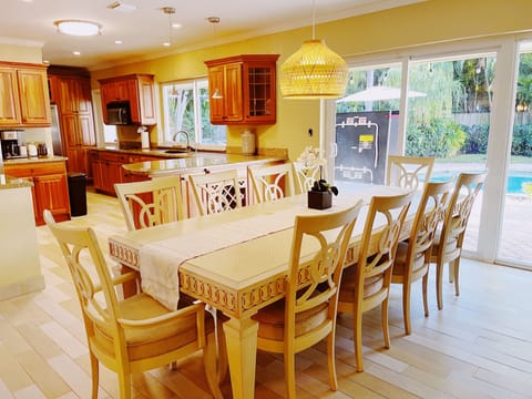 Our large dining table, open to the kitchen with great views of the backyard.