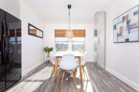 The sunlight filled dining room provides the perfect space for dining or playing
