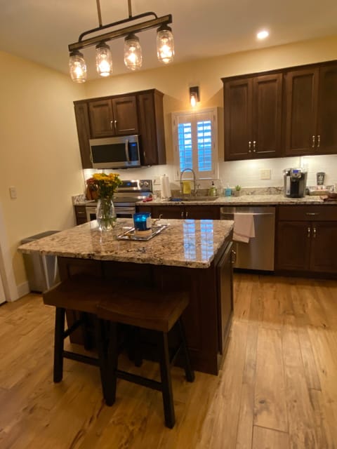 Custom kitchen cabinets granite counters.
Island with chiseled eve granite top.