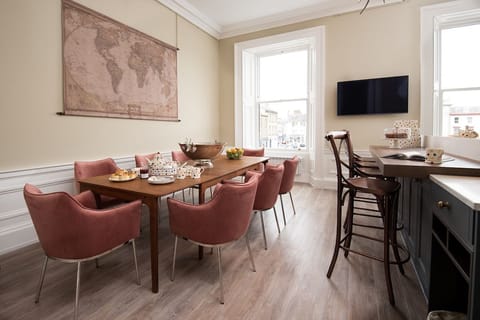 The Linen House - the kitchen is home to a large dining table seating up to twelve guests offering a relaxed yet sophisticated spot for both informal dining and more formal entertaining