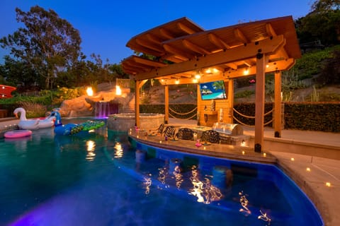 Huge LED lit pool with swim up bar, covered kitchen, 60" roku tv.