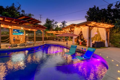 Amazing colorful LED lit pool with multi changing colors and large pergolas.