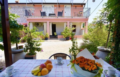 The front of the house and the terrace of the ground floor apartment