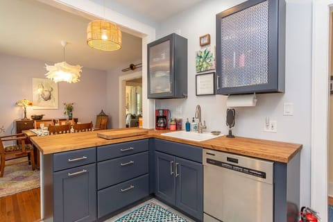 The colorful kitchen has coffee and tea, and a dishwasher.