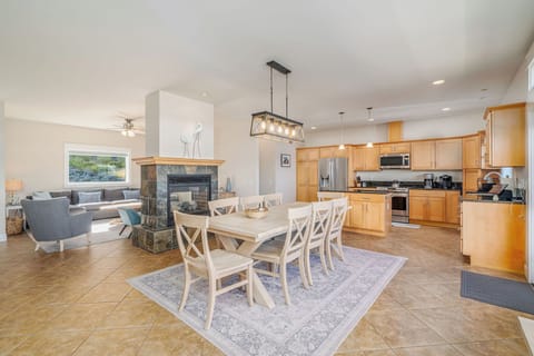 Open concept living, dining and kitchen with fireplace.