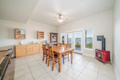 Rec. room with TV, pool table, game table, and wet bar.