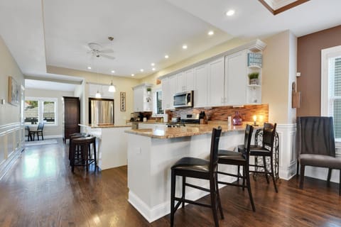 Large kitchen with several bar stools