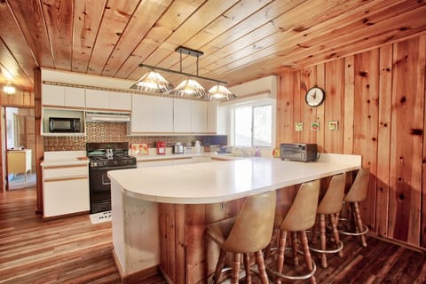 Open concept kitchen with lots of counter space and seating at the counter.