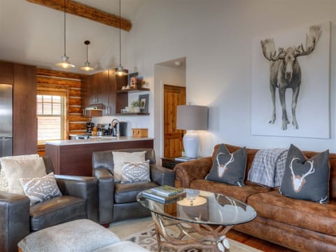 Living room open to kitchen, dining, views.