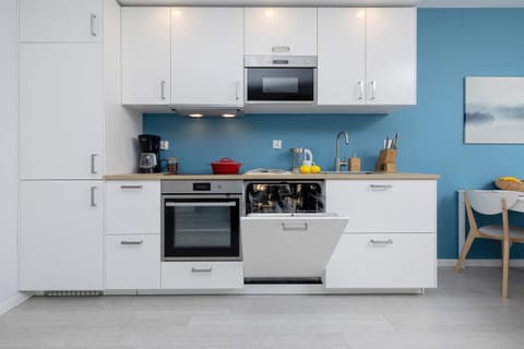 A functional kitchen with white cabinets and high-quality appliances creates a place to cook home-cooked meals.