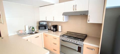 The full kitchen is well-equipped with modern appliances, including a stove, refrigerator, and microwave. It also features ample countertop space and storage, allowing for convenient meal preparation and cooking during your stay.