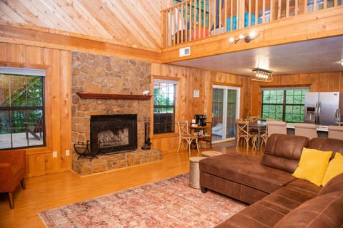 The main living space is open and airy with a wood-burning fireplace.