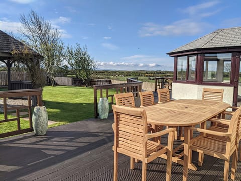 Relaxing sitting area on the decking | Brambleside, Mawbray near Allonby