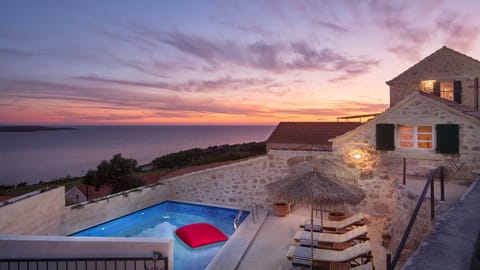 A heated pool, sun loungers