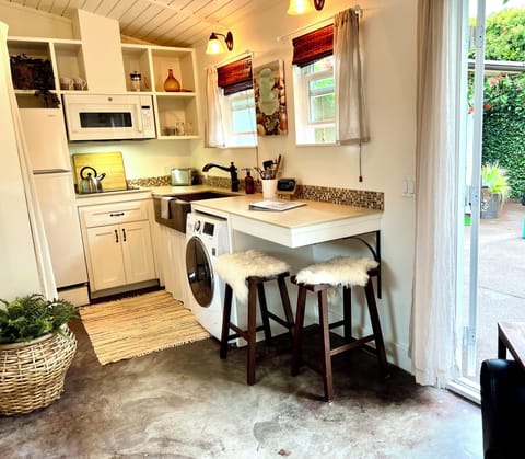 Full kitchen including copper sink, induction & convection cooking options.