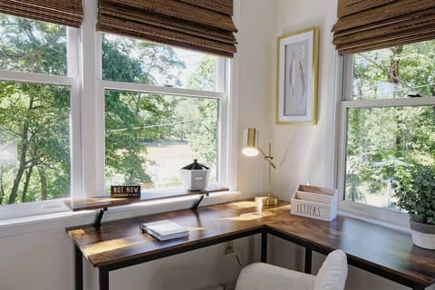 View of the desk and workspace; lake and tree views out of every window of the master