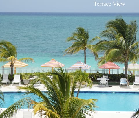 From the building's terrace, you can see a pool right by the beach.