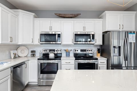 Prep and cook meals in the spacious main-level kitchen, featuring double stove/ovens and double microwaves