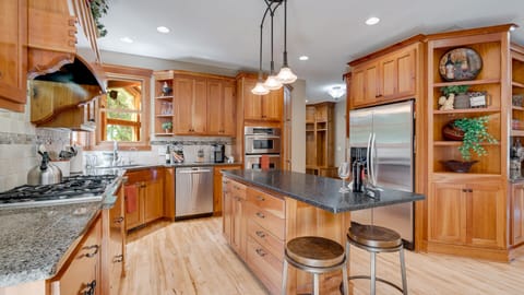 Prepare meals in spacious well equipped kitchen with island