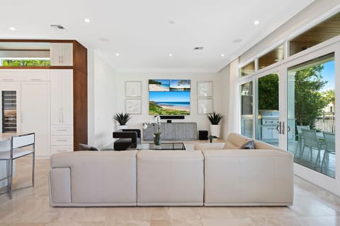 Informal living area with three TVs for multi-viewing purposes.