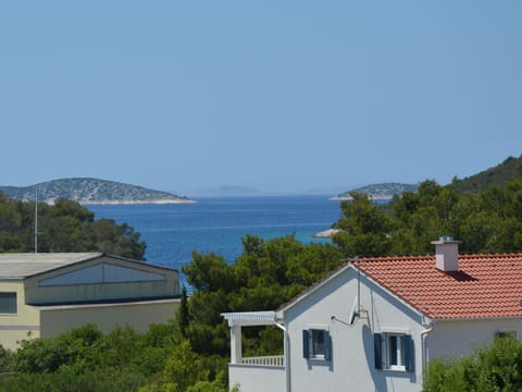 Sky, Water, Window, Azure, Tree, Body Of Water, Mountain, Coastal And Oceanic Landforms, Plant, Building