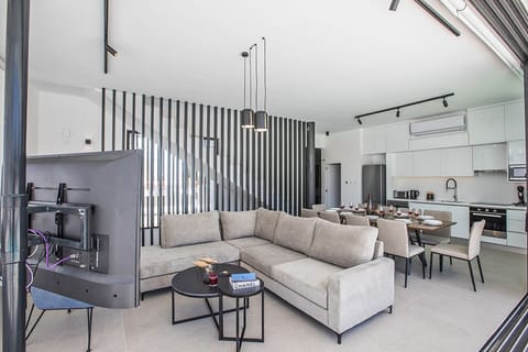 Living room with comfortable corner sofa, coffee table and Smart TV