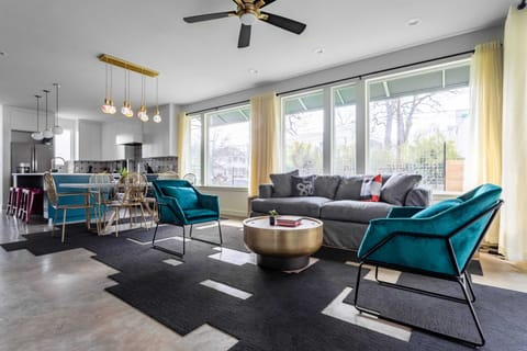 Open-concept living and dining area with a stylish kitchen and large windows