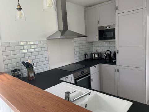 A modern kitchen with all appliances, fan oven, induction hob, microwave...
