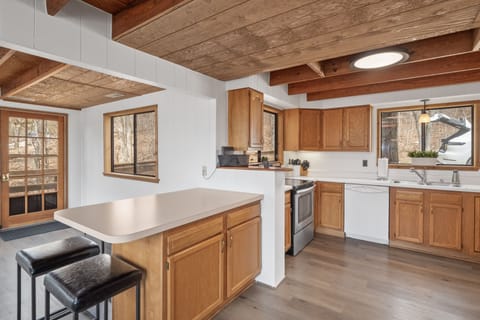 Open Kitchen fully stocked to prepare any meal. 4 Barstools to max seating. 