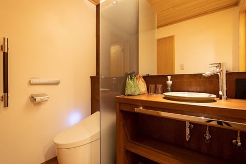 Toilet with washbasin & hot water wash