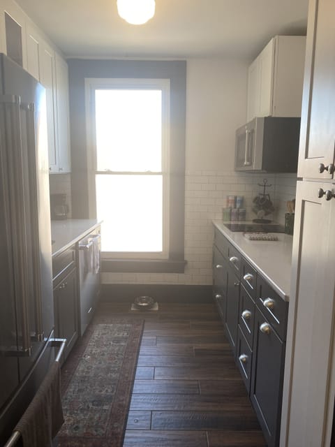 Galley kitchen with Opening overlooking the Living Room & Counerbar area
