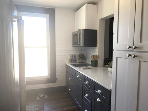 Galley kitchen with Opening overlooking the Living Room & Counerbar area
