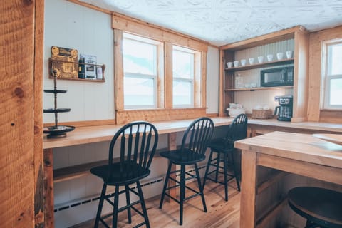 Kitchen has 3 bar stools by the counter and 2 by the island