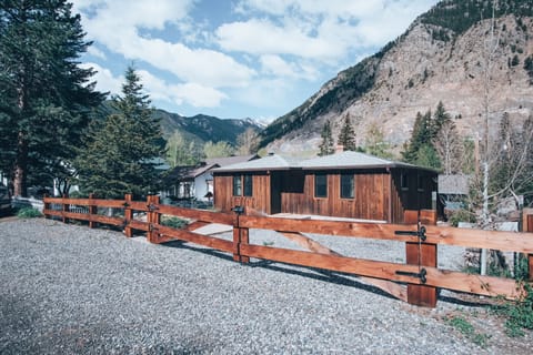 Gated yard with parking for two cars inside it.