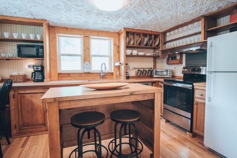 Kitchen with a bar for 3 and an island for 2. Very well stocked kitchen.
